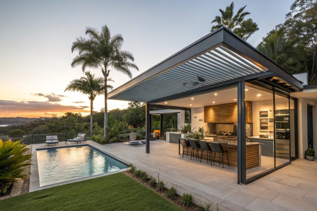 Modern Queensland home with seamless pergola extension, louvred roof system, integrated outdoor kitchen, swimming pool nearby, lush tropical Gold Coast landscaping, sunset lighting